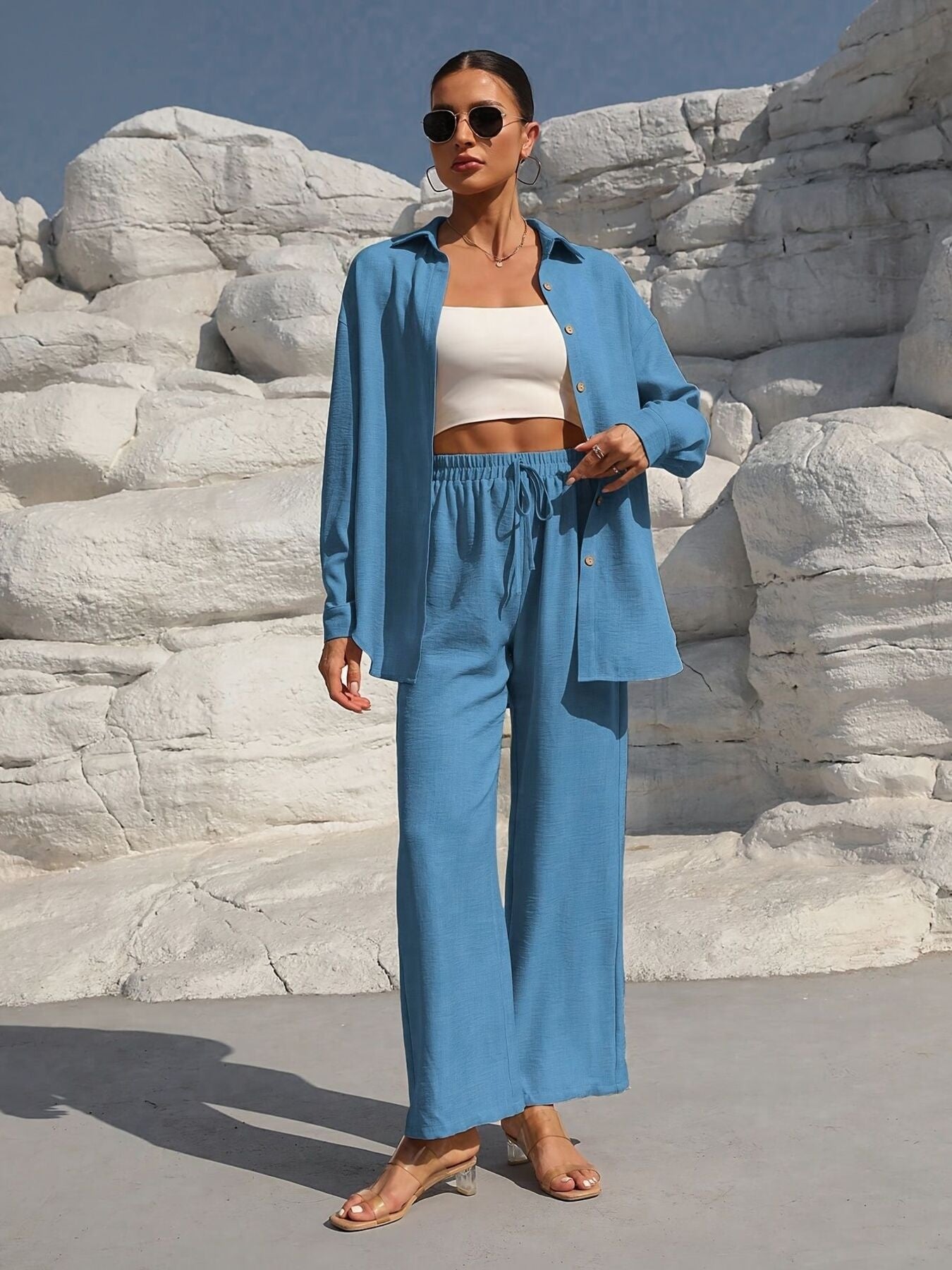 Button Up Long Sleeve Shirt and Pants Set in blue, worn open over a white crop top