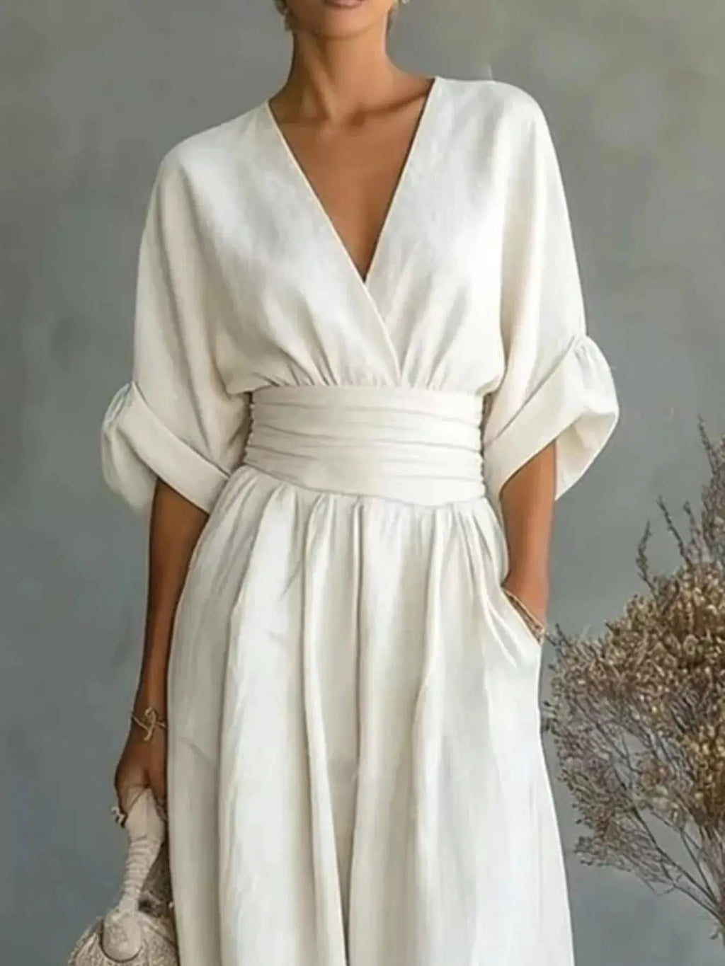 Belle Bijouix white wide-leg jumpsuit with plunging V-neck and wrapped waist belt