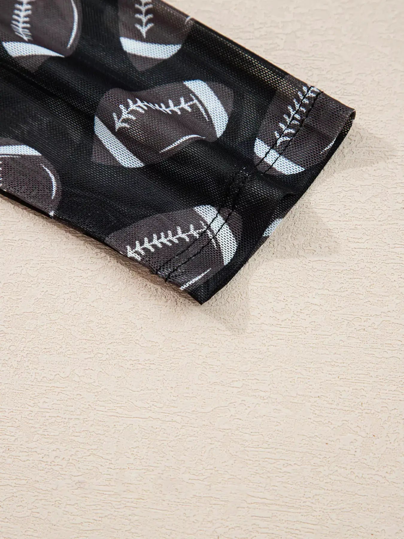 Game Day Mesh Sheer Long Sleeve Top by Belle Bijouix, black mesh with football-print accents