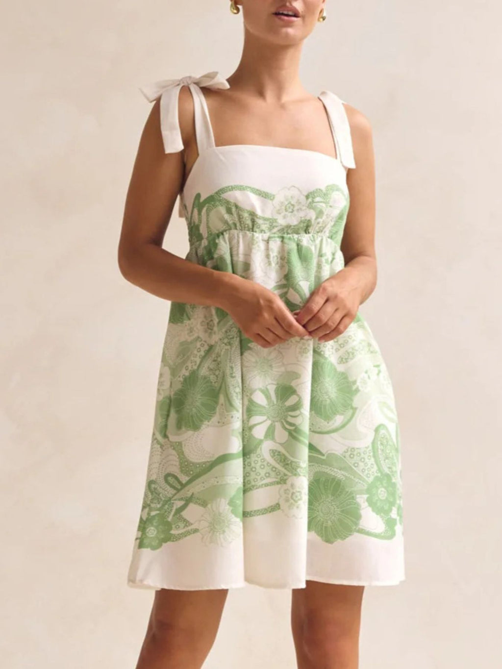 Printed Tie Shoulder Mini Dress by Belle Bijouix, pocketed green floral print with smocked bodice and tie straps.