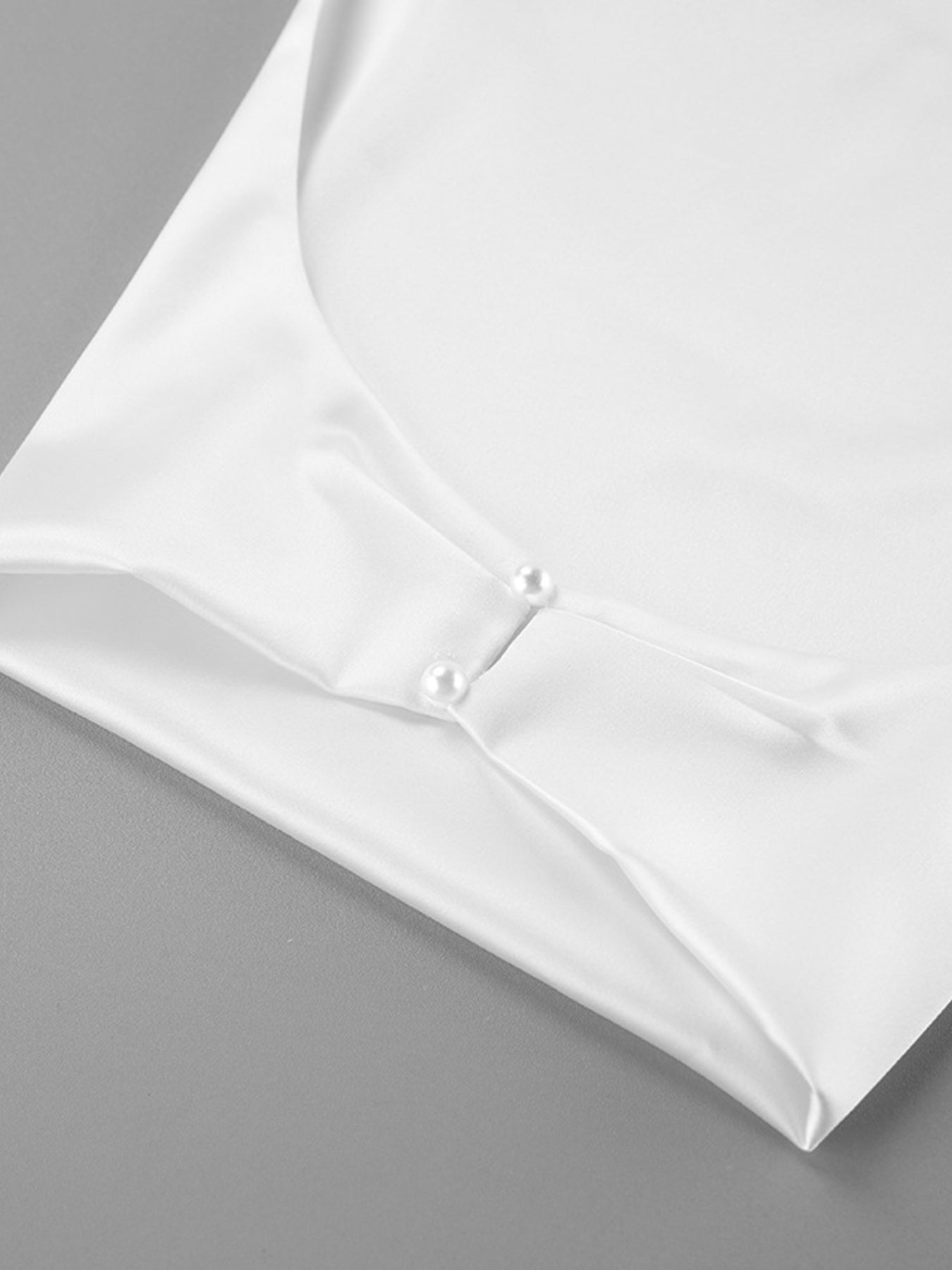White satin halter-neck cami with pearl buttons