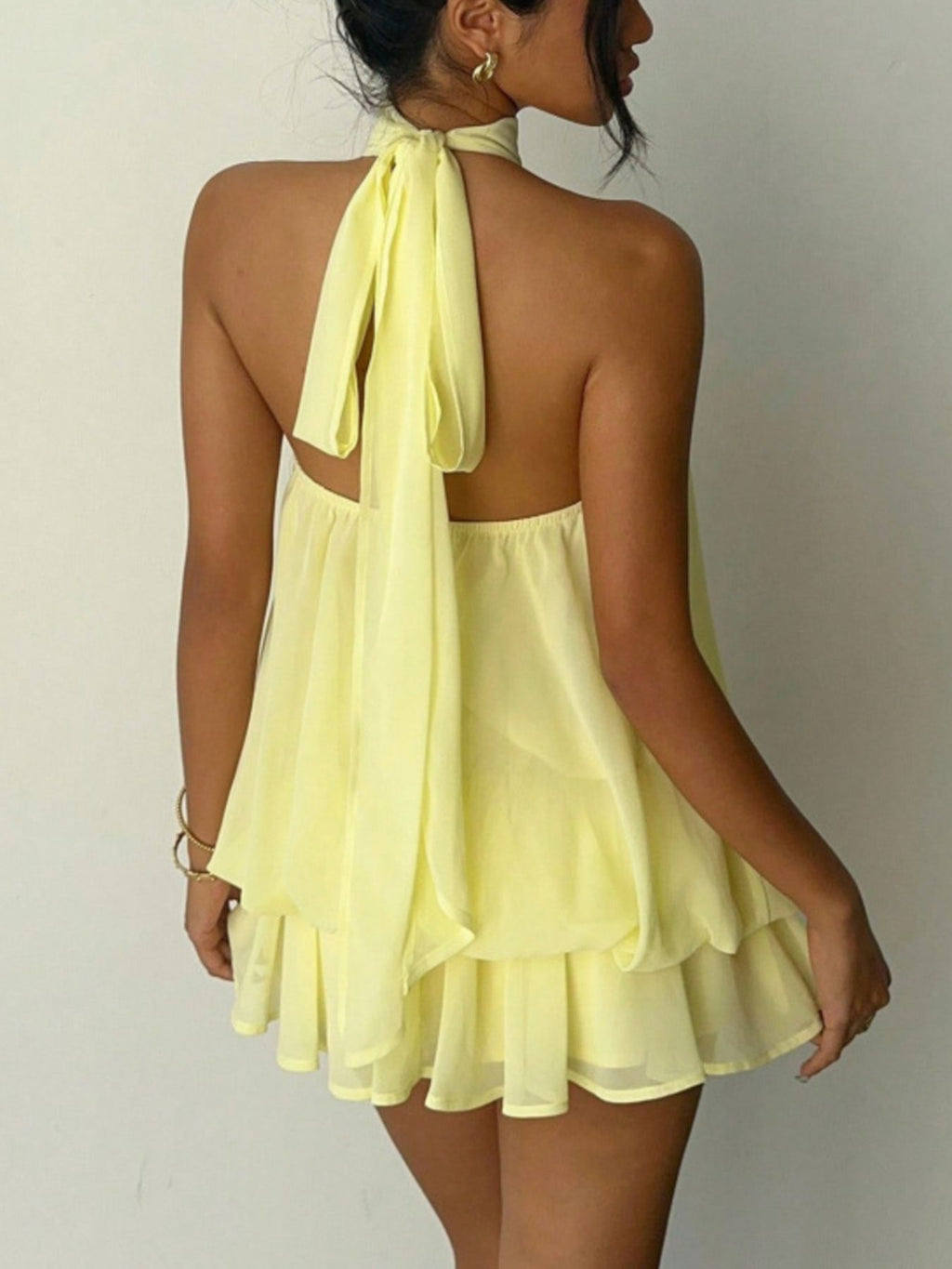 Halter Neck Layered Mini Dress in pale yellow chiffon, tiered with a back tie.