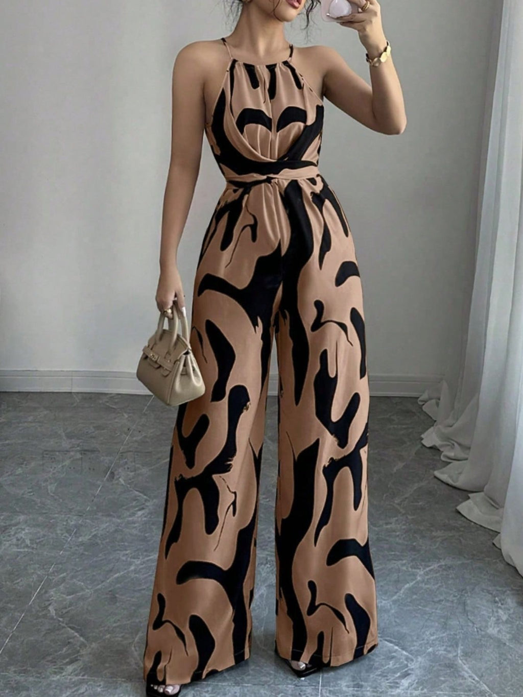 Abstract Print Sleeveless Wide-Leg Jumpsuit in tan with black abstract pattern, belted waist