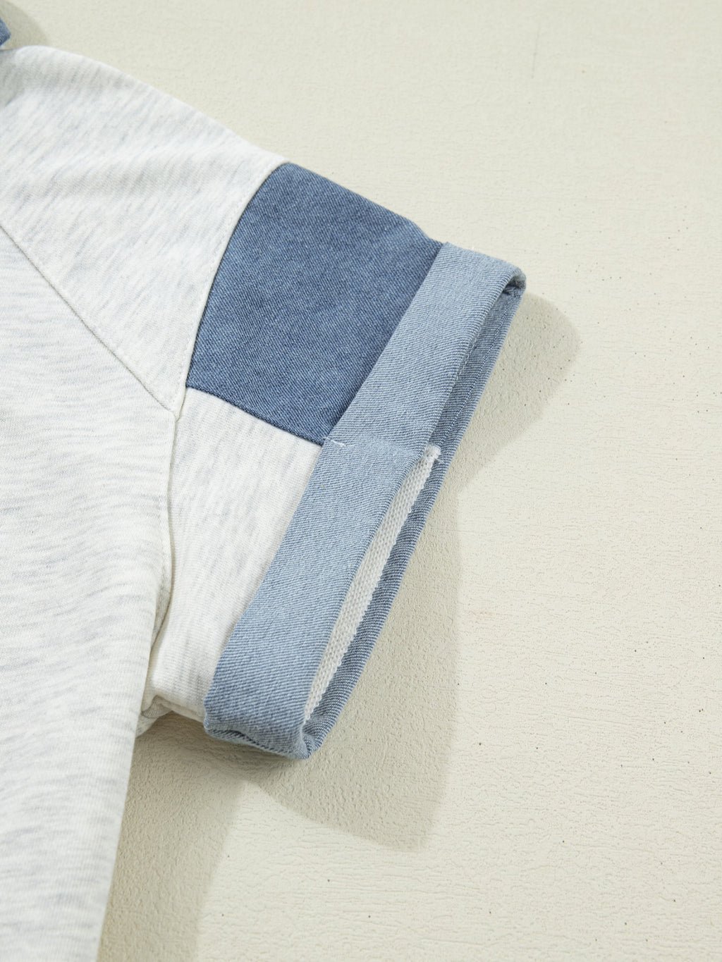 Contrast Trim Button Detail Top with light gray body and blue denim shoulder patch, rolled cuffs