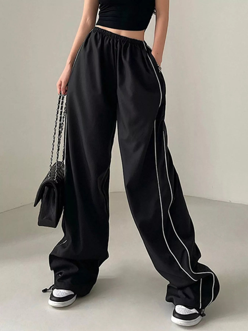 Elastic Waist Wide Leg Pants in black with white piping and elastic waistband by Trendsi