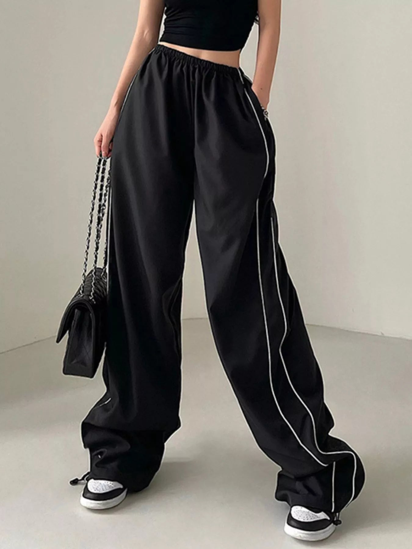 Elastic Waist Wide Leg Pants in black with white piping and elastic waistband by Trendsi