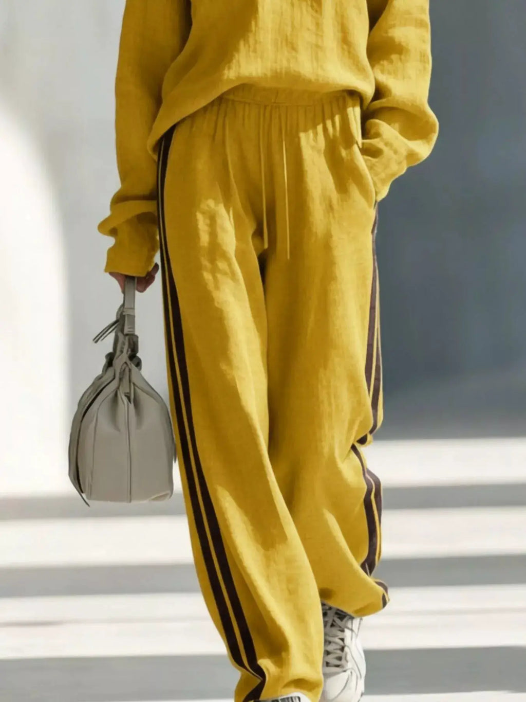 Contrast V-Neck Top and Striped Pants Set in mustard with black side stripes; model carries a gray handbag.