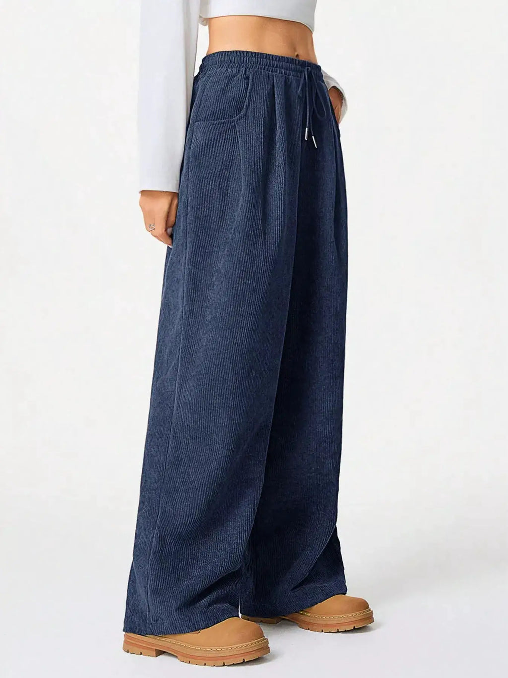Casual corduroy wide-leg pants in navy with a drawstring waist and pockets.