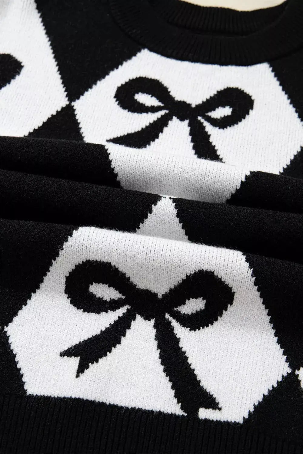 Bow Pattern Long Sleeve Contrast Sweater by Belle Bijouix, black and white knit