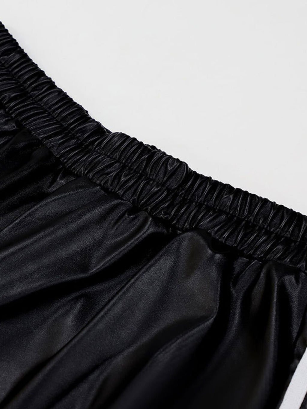 Striped wide-leg pants in black satin-like fabric with an elastic smocked waistband