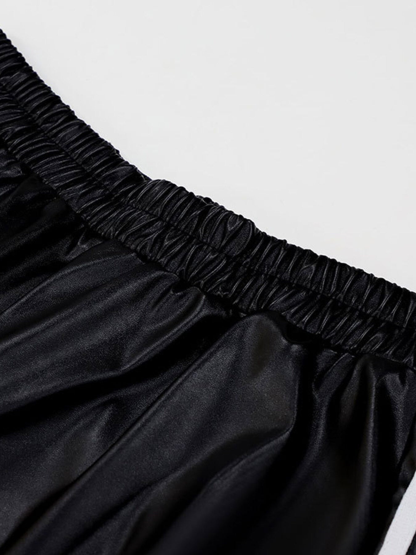 Striped wide-leg pants in black satin-like fabric with an elastic smocked waistband