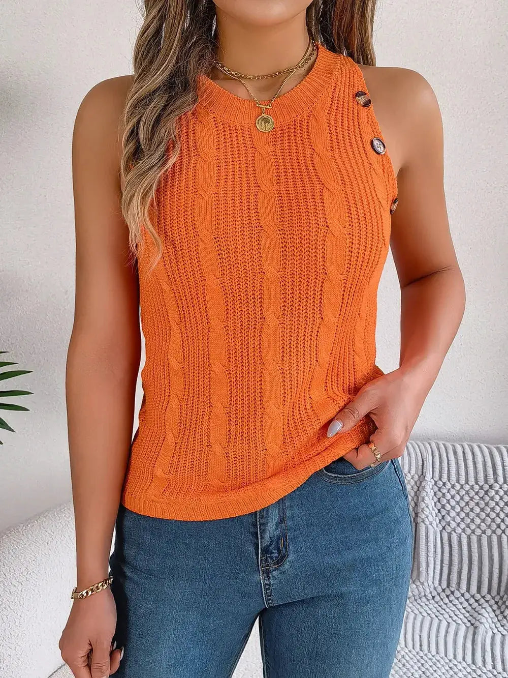 Cable-Knit Round Neck Vest in orange; sleeveless top with side button accents.